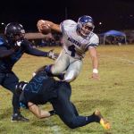 Raiders RB Hank Sablan hurdles over a defender to ick up positive yards on the play. (photo by Joey Blas)