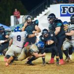 Raiders Manny Cruz puts a stop on Angels QB. (photo by Joey Blas)