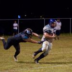 Raiders Mike Borja shakes off a defender and picks up 5 more yards on the play. (photo by Joey Blas)