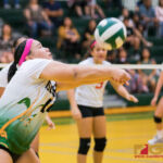 JFK Islander's Francine Villena bumps ball over to St. John Knight's side of the court. (Photo by Michael Blas)