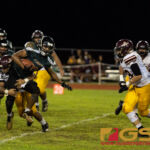 JFK Islander's Deante Delgado drives the ball forward, but FD Friar's Roy Chargulaf makes the tackle. (Photo By Michael Blas)