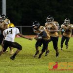 JFK Islander's QB Andrew Perez opts to run the ball for a first down. (Photo by Michael Blas)