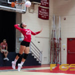 St. John's Knights Hallie Wigsten leaps up to serve the ball to the Notre Dame Royals. (Photo by Michael Blas)