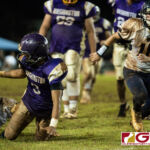 George Washington Geckos Jerome Quichocho loses control of the ball, but recovers it during mid fall. (Photo by Michael Blas)