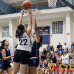 Academy Cougars Therese Fergurgur takes a shot while Notre Dame Royals Brianne Leon Guerrero gets her hands up to block. (Photo by Michael Blas)