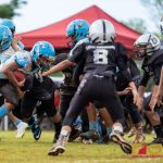 Angels Sage Castro drives the ball forward for a short gain on the play. (Photo by Michael Blas)
