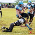 Raiders Peter Roy Perez makes the tackle on Angles Vance Meno. (Photo by Michael Blas)