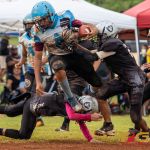 Angels Vance Meno leaps over a tackler. (Photo by Michael Blas)