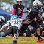 Raiders Peter Mesa breaks through Angels Sage Castro's tackle. (Photo by Michael Blas)
