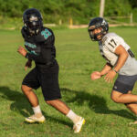 The Silver Mustangs Gabe Stanley, left, and Kamerin Toves, right, run a passing route at practice. (Photo by Michael Blas)