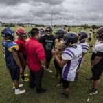 The offense huddles around coach Danny Manibusan for the play calling. (photo by Michael Ebio)