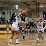 St. Paul Warriors Kirsten Silva gets fouled on her way to the bucket. (Photo by Michael Blas)