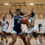 GW Geckos Bila Aguon powers her way into the paint while St. Paul Warriors Keiani Pangelinan is there to contest her. (Photo by Michael Blas)