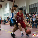 St. John's Knights E. Yu dribbles the ball in for a shot at the bucket while St. Paul Warriors Aiken keeps the pressure on. (Photo by Michael Blas)