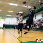 St. Paul Warriors Reo Aiken gets a shot off as he gets shoved out of bounds. (Photo by Michael Blas)