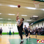 JFK Islanders Ralf Manalac fires the ball over St. Paul Warriors Reo Aiken into the net. (Photo by Michael Blas)