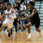 St. Paul Warriors Jahmar White sprints down the sideline while FD Friars Tony Quinene paces with him. (Photo by Michael Blas)