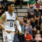 St. Paul Warriors Jahmar White with the flex after hitting the far three to end the first quarter. (Photo by Michael Blas)