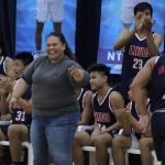 The bench applauds Bulldog Dale Bautista as he draws an offensive foul. (photo by Robert Balajadia)