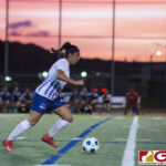 Guam High Panthers Alexandra Hawkes controls the ball down field as the Cougars bench looks on. (photo by Bout It Productions)