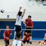 St. John's Knights Matthew Del Carmen spikes through Harvest Eagles Alan Thomas to score. (Photo by Michael Blas)