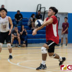 St. John's Knights Kian Malakooti connects with a bump off a Harvest Eagle serve. (Photo by Michael Blas)