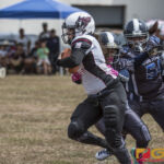 Team Legacy's Olivia Elliot powers her way through the Island Stunnerz defense. (photo by Bout It Productions)