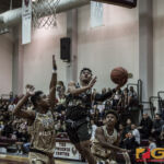 Team Supreme's Jahmar White gets around Team Elite defenders for the bucket. (photo by Bout It Productions)