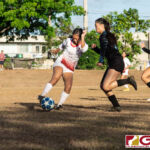 St. John's Knights Hallie Wigsten clears the ball off of Warriors attacker Janniliese Quintanilla. (Photo by Michael Blas)