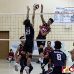 Okkodo Bulldogs Jarwin Espiritu sends a powerful spike over the net while Warriors John Kyle Rabino goes up to contest. (Photo by Michael Blas)