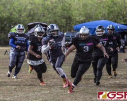 Island Stunnerz Dani Vaughn gets past the Sindalu Raiders while looking down field for an opening. (photo by Bout It Productions)