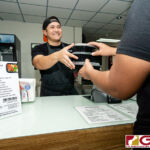Boka Box Nutrition Professional/Owner Jesse E. Rosario hands over a set of meals to a customer. (Photo by Michael Blas)