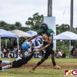 Guam Packers Ethan Cruz stiff arms his defender. (photo by Bout It Productions)