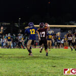 FD Friars Javian Cruz attempts a reception in the first half of the opening IIAAG High School Football game. (Photo by Michael Blas)