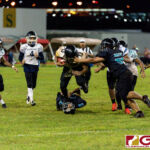 JFK Islanders Jacobe Quinata drives through the Dolphins defense for the first down. (Photo by Michael Blas)