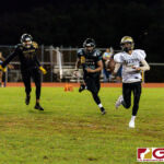 Tiyan Titan Kaekoa Leon Guerrero scrambles for some room as the Islanders close in for the sack. (Photo by Michael Blas)