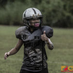 Guam Raiders Kaekala Leon Guerrero checks his place in line with the sideline referee. (photo by Bout It Productions)
