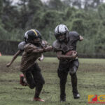 Guam Raiders Tristan Jay Burgos rushes by Tamuning Steelers Trey Blas Fields. (photo by Bout It Productions)