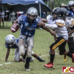 Southern Cowboys Christian Manglona rushes by Tamuning Steelers Trey Blas Fields. (photo by Bout It Productions)