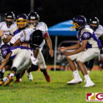 JFK Islander RB Jacobe Quinata gets stopped by a Gecko defender after a short gain on the play. (Photo by Michael Blas)