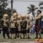 The Guahan Eagles huddle up for the next play. (photo by Bout It Productions)