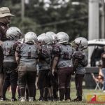 The Barrigada Crusaders huddle up for the next play. (photo by Bout It Productions)