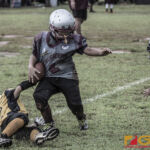 Barrigada Crusaders Blake Borja gets taken down by Guahan Eagles Ashton Quintanilla. (photo by Bout It Productions)