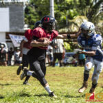 Faha Outlaws Zavier Camacho introduces the stiff arm to Southern Cowboys Raymond Blas. (photo by Bout It Productions)