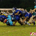 The GW Gecko Noah Quichocho knocks the ball loose off of Southern Dolphin Conan Baza for the defense to recover. (Photo by Michael Blas)