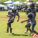 Guam Raiders Ethan Guerrero looks to get past the Island Broncos defense. (photo by Bout It Productions)