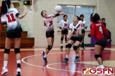 St. John's Knight Ella Wigsten gets a touch on the ball off a serve from the Raiders. (Photo by Michael Blas)