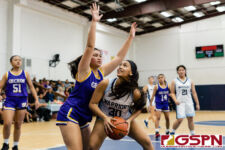 St. Paul Warrior Jenna Almaguero looks for the net while GW Gecko Kirsten Santos covers. (Photo by Michael Blas)