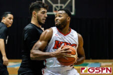 KFC Bomber Divine Cox powers his way towards the basket while being defended by Wu Tangs Amir Khozhlev. (Photo by Michael Blas)