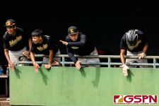 The JFK Islander dugout cheers on their team as they regain momentum. (Photo by Michael Blas)